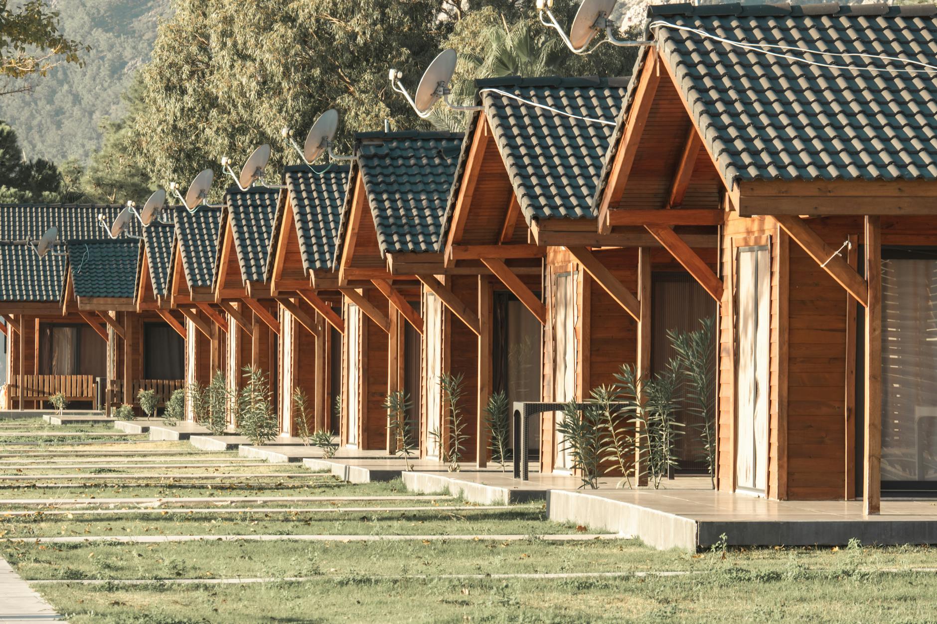 Cozy wooden cabins in a serene resort ideal for a summer getaway and relaxation.